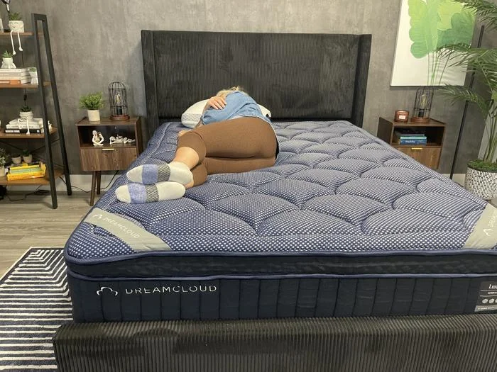 Our tester side sleeping on a DreamCloud Luxe Hybrid