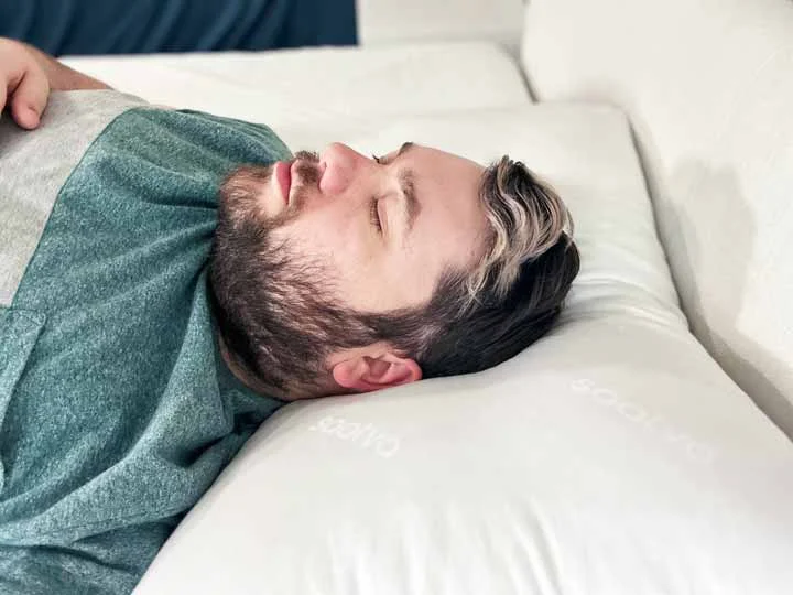 An image of a man sleeping on his back using the Saatva Down Alternative Pillow. An image of a man sleeping on his back using the Saatva Down Alternative Pillow.