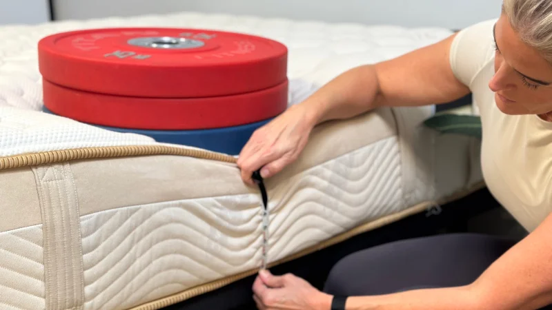 Measuring the sinkage from weight plates along the edge of the Saatva Loom & Leaf Mattress