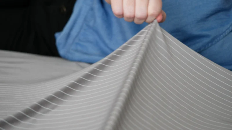 Our tester pinching and pulling on a sheet