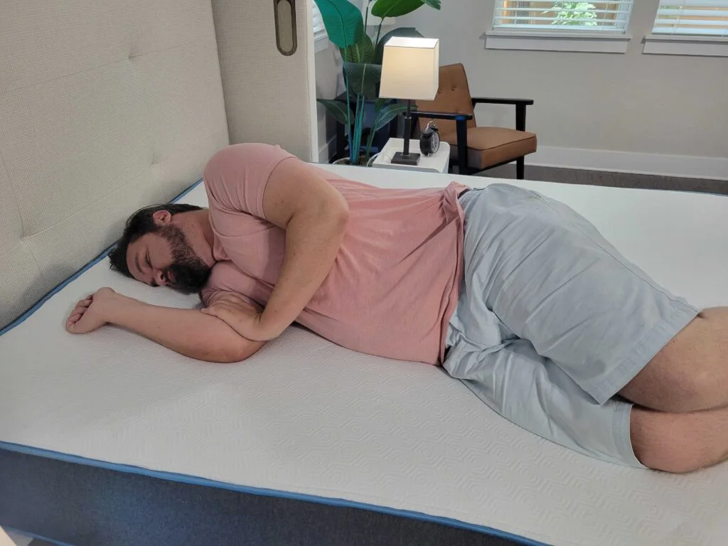 Man resting on his side on the Bear Original Mattress
