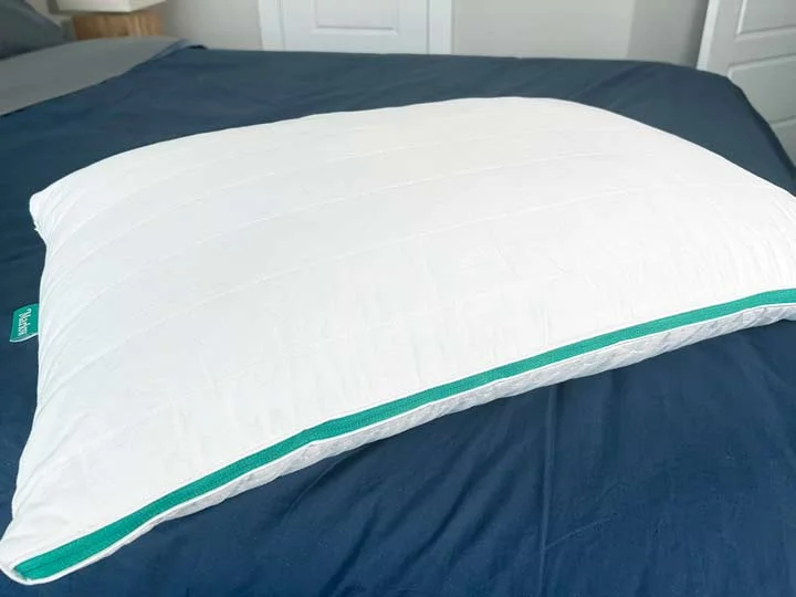 A picture of the Marlow pillow on a bed, showcasing its cotton cover. A picture of the Marlow pillow on a bed, showcasing its cotton cover.