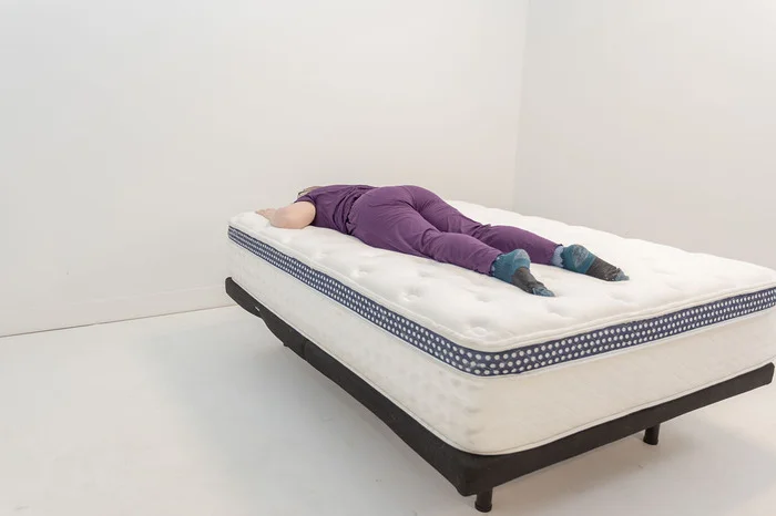 Tester tries out The WinkBed in the stomach sleeping position