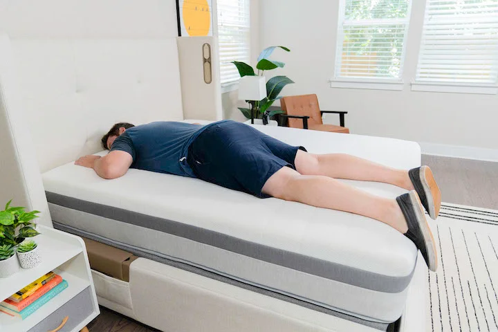 a man sleeps on his stomach on the Helix Plus mattress