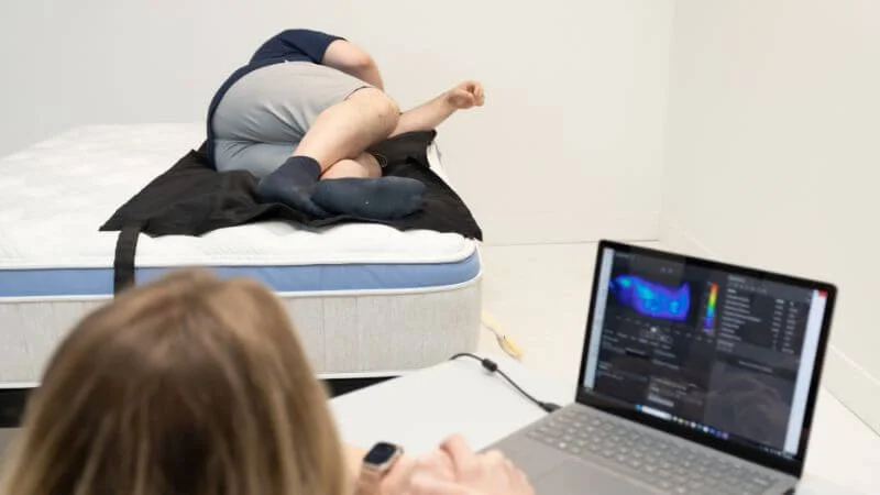 Our team of testers measuring pressure map results for the Bear Star Hybrid mattress