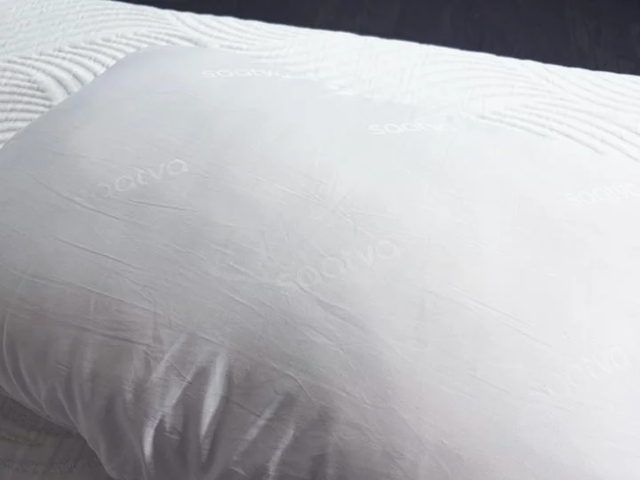An image of the white cotton cover of the Saatva Down Alternative Pillow. An image of the white cotton cover of the Saatva Down Alternative Pillow.