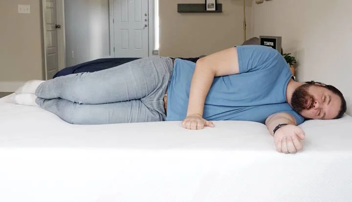 A man sleeps on his side on the Tempur-Cloud A man sleeps on his side on the Tempur-Cloud