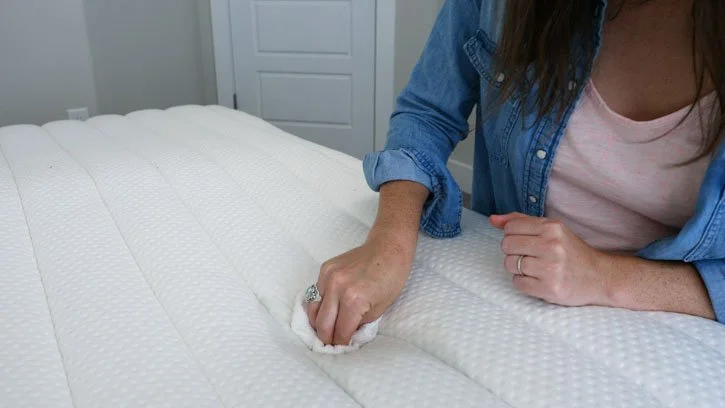 How to Clean a Pillow Top Mattress - The Easiest Tips and Tricks A woman cleans the top of a mattress