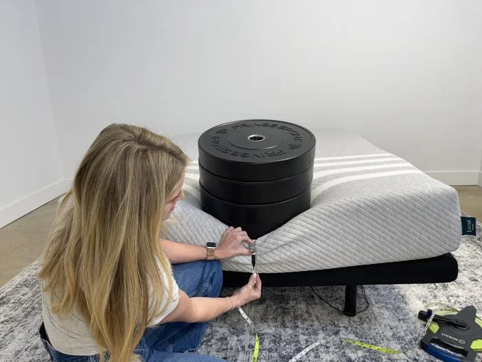 Measuring weight plates on the edge of a Leesa Original Mattress
