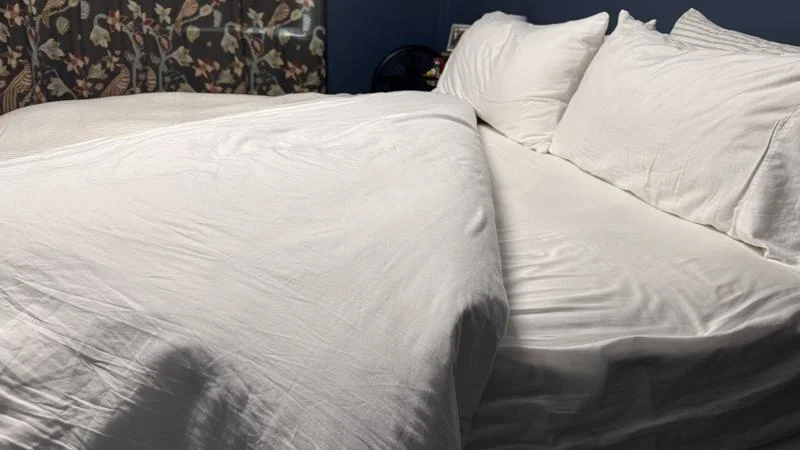 Side view of a bed made with Saatva Organic Sateen Sheets