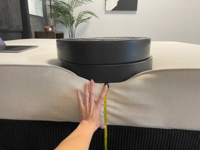 Measuring a few weight plates on the edge of a Boring Hybrid Mattress