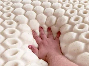 A close up image of a hand pressing into the MOLECULE CopperWell topper.