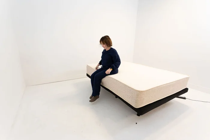 Tester performing the seated edge support test on the Birch natural mattress