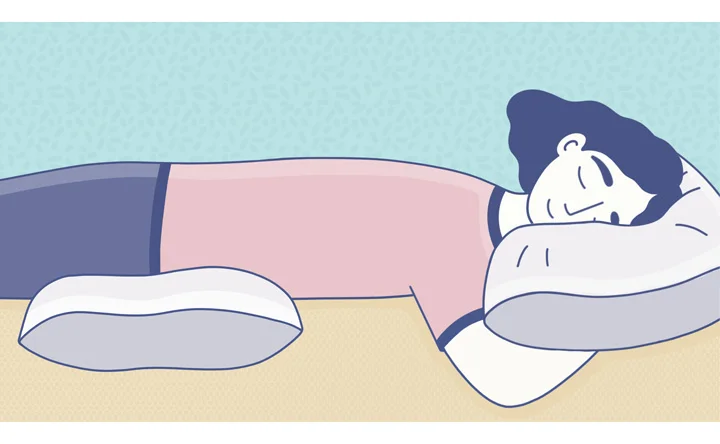 Illustration of a person sleeping on their stomach with a pillow under their hips
