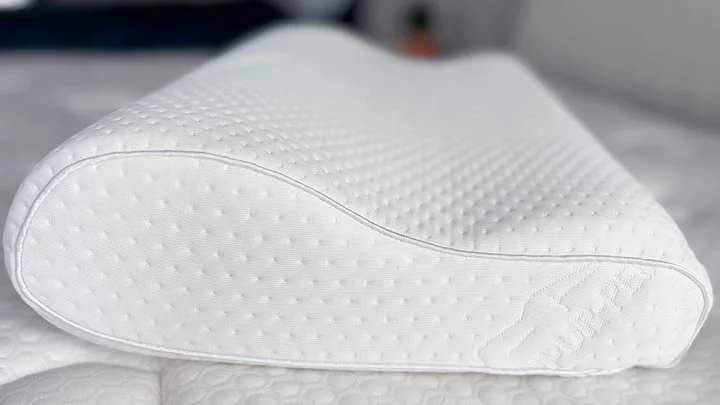 A close up picture showing off the ergonomic shape to the TEMPUR-Neck pillow.