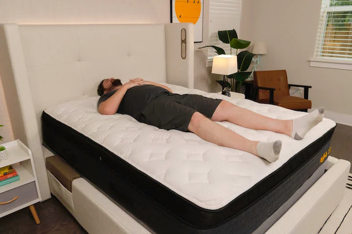 a man sleeps on his side on the Nolah Evolution Comfort + mattress