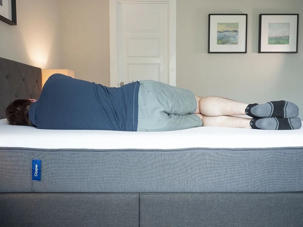 A man sleeps on his side.