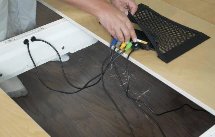A close shot a man attaching the control box to the Tuft & Needle adjustable base A close shot a man attaching the control box to the Tuft & Needle adjustable base