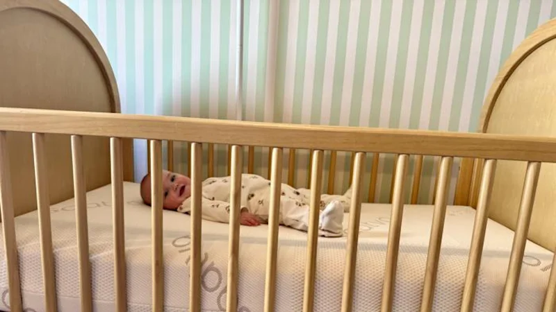 baby smiling on the saatva crib mattress