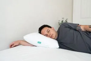 A man sleeping on the Marlow pillow