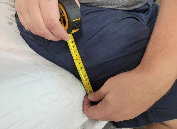 A man tests the edge support of the Nectar Luxe