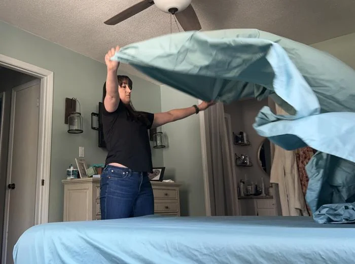 Making a bed with Threshold Performance 400 Thread Count Sheets