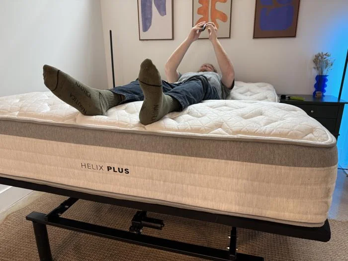 Our tester takes decibal readings while operating the Brooklyn Bedding Ascension Luxe Adjustable Base