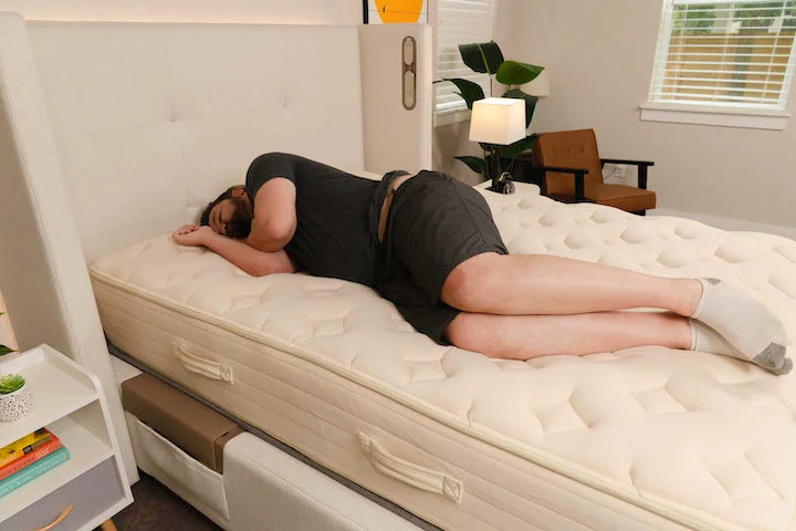 A man sleeps on his side on the Bear Natural mattress