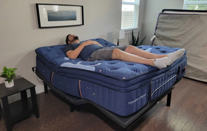 A man uses the Zero Gravity function of the Nolah adjustable base