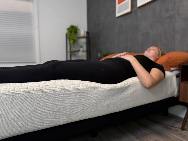 Testing edge support by lying down near the perimeter of the Tuft & Needle Original mattress