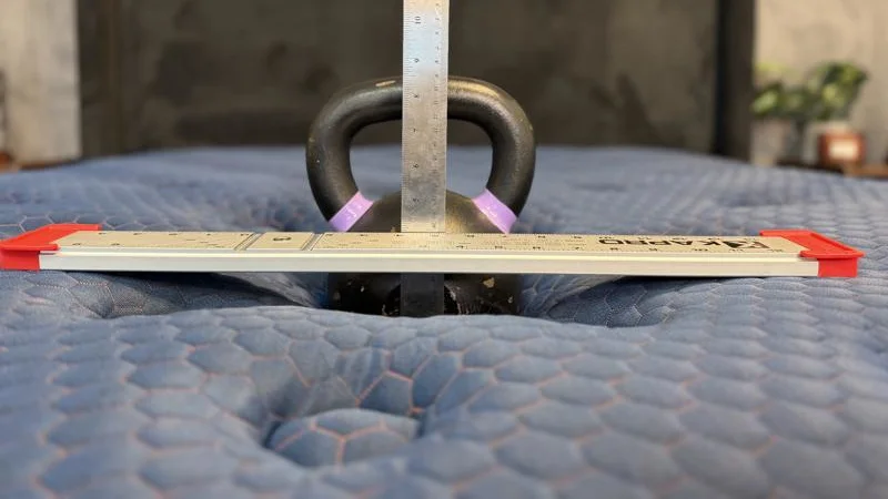 Kettlebell sinkage test on the Brooklyn Bedding Aurora Luxe Mattress