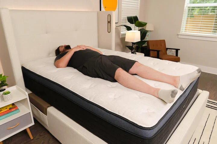 a man sleeps on his back on the Helix Midnight Luxe mattress