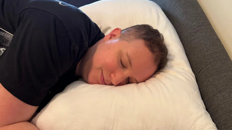 Our tester side sleeping on the Saatva Down Alternative Pillow