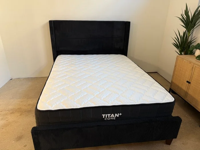 The Titan Plus Core mattress on a black bed frame