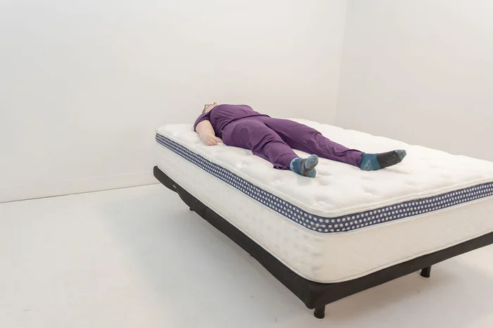 Tester tries out The WinkBed in the back sleeping position.