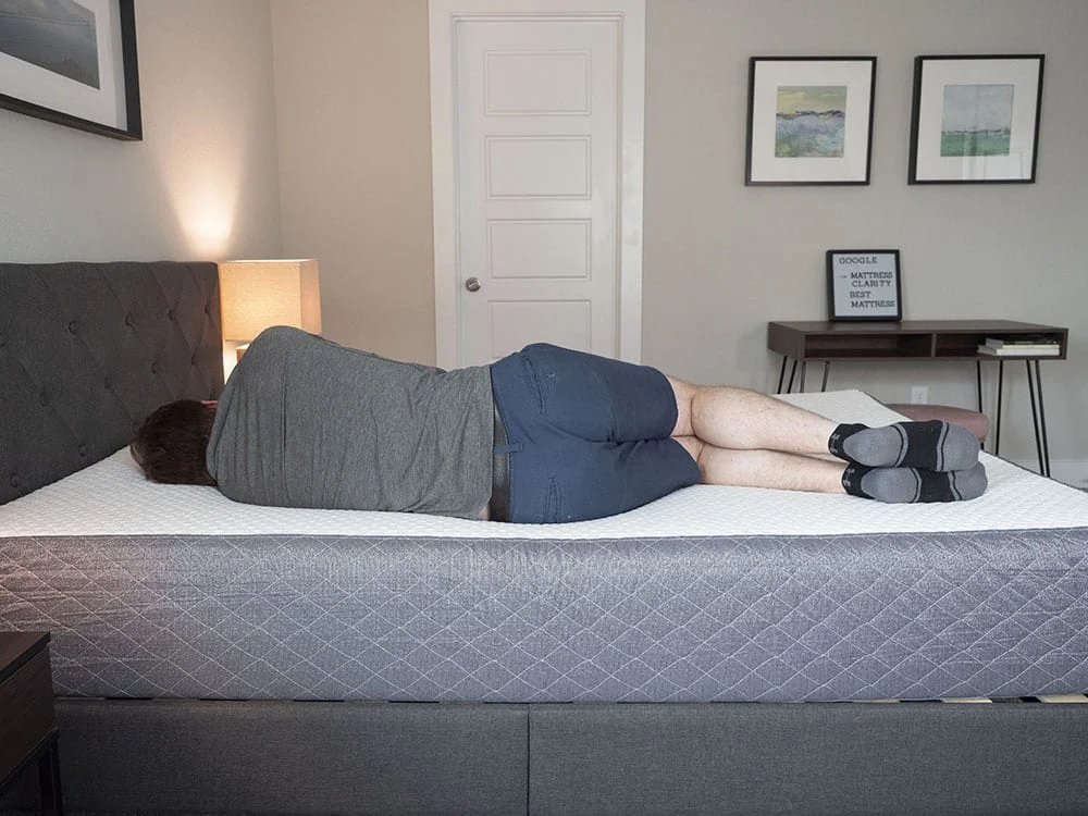 A man lies on his side. A man lies on his side.