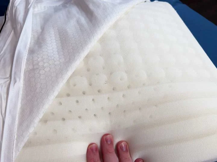 A close up on the Nolah Cooling Foam pillow to show the ridges and perforations for airflow. A close up on the Nolah Cooling Foam pillow to show the ridges and perforations for airflow.