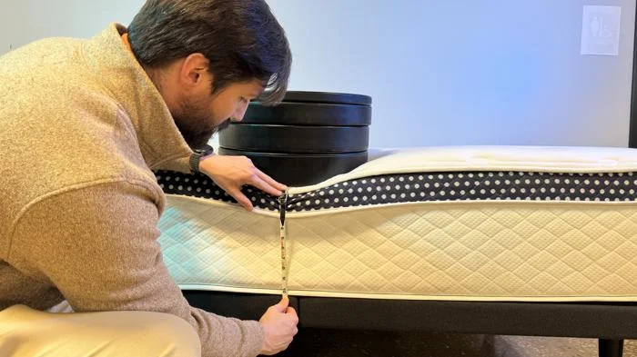 Measuring weight plates on the edge of the WinkBed Plus Mattress