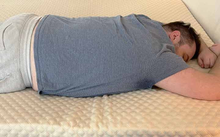 A man rests on his stomach while using the Nolah Mattress Topper. A man rests on his stomach while using the Nolah Mattress Topper.
