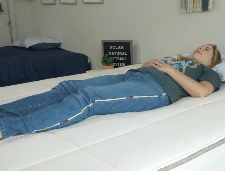 Woman sleeping on her back on Nolah Natural.