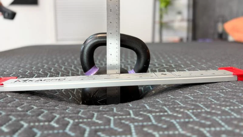 Kettlebell sinkage test on the Tuft & Needle Mint Hybrid Mattress