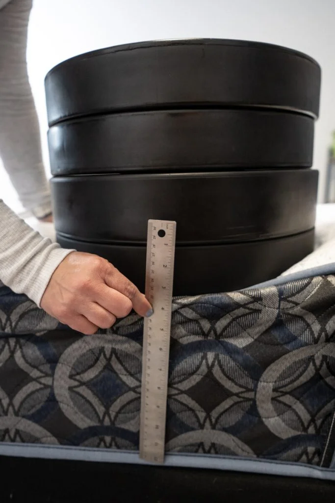 Four weight plates on the Serta Perfect Sleeper Cascade Range Medium mattress