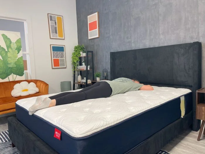 A woman lays on her stomach on the Big Fig Classic mattress