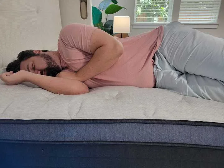 a man sleeps on his side on the Helix Midnight Luxe