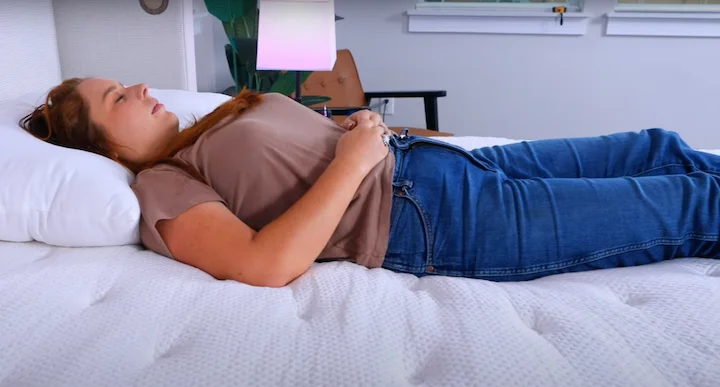 a woman sleeps on her back on the PlushBeds Signature Bliss