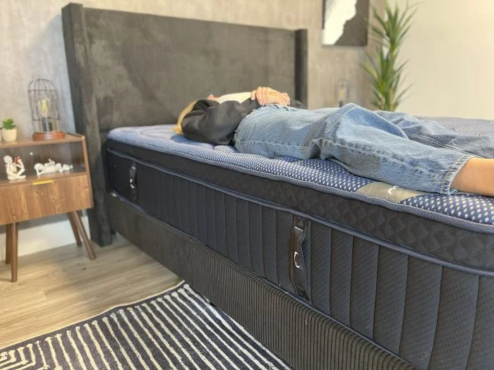 Our tester lays on her back on the DreamCloud Luxe Memory Foam mattress