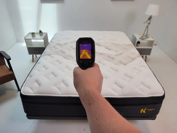 A man points a heat gun at the Nolah Evolution mattress