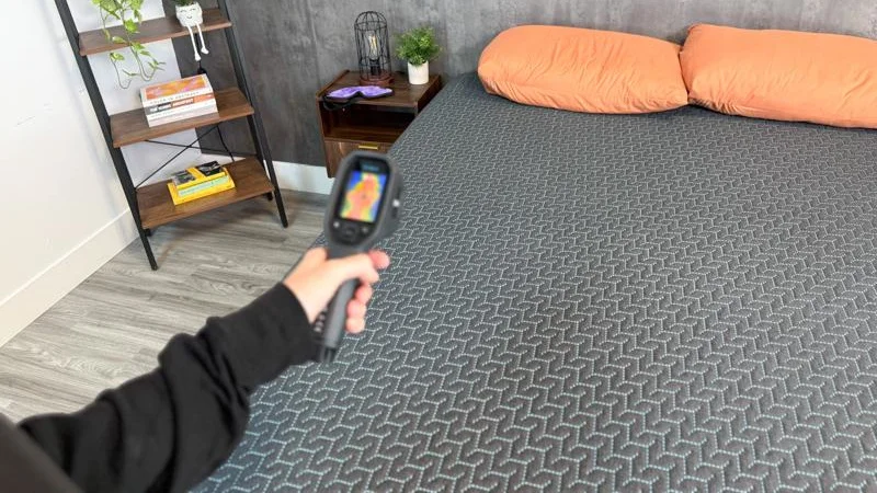 Our tester takes thermal readings of the Tuft & Needle Mint Hybrid Mattress