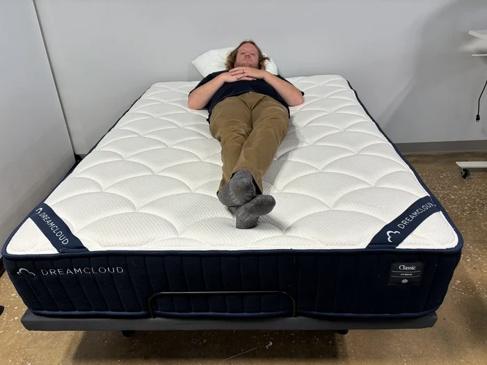 Heavyweight tester Matt resting on his back on the DreamCloud Classic Hybrid