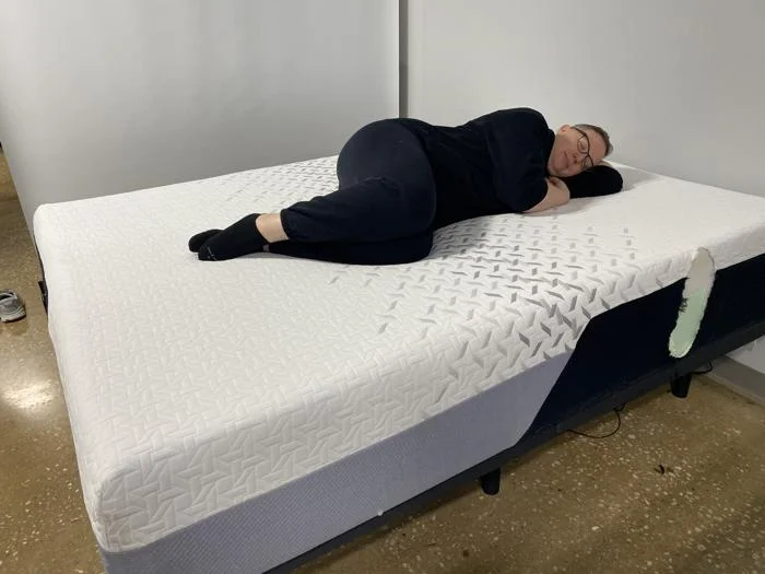 Our tester side-sleeping on the Nectar Premier Memory Foam